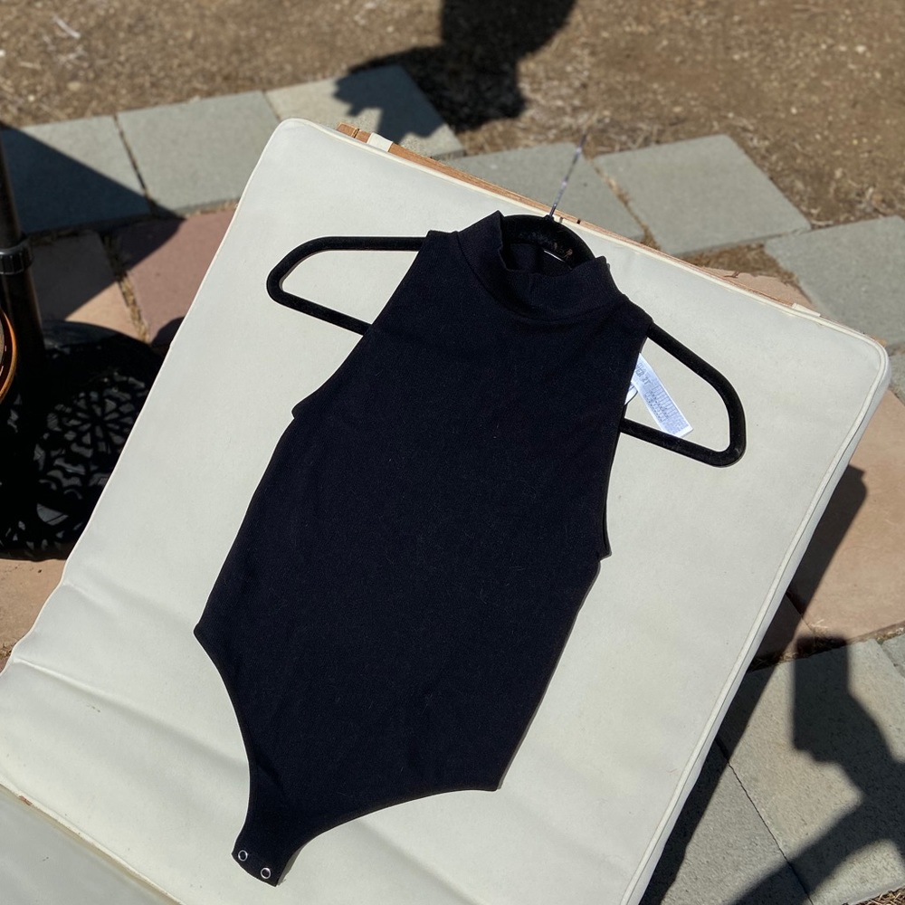 Black ribbed turtle neck bodysuit. Never worn